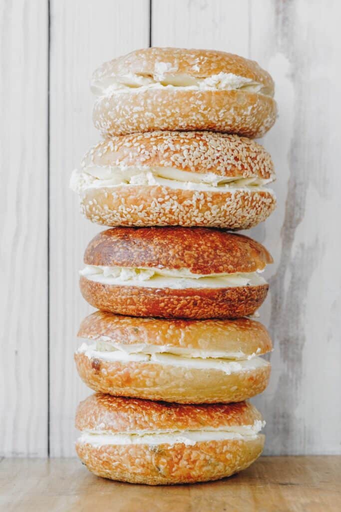 A stack of bagels with cream cheese.